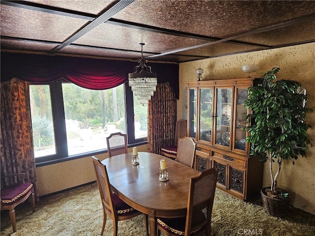 dining area with coffered ceiling and a notable chandelier