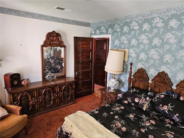 carpeted bedroom featuring visible vents and wallpapered walls