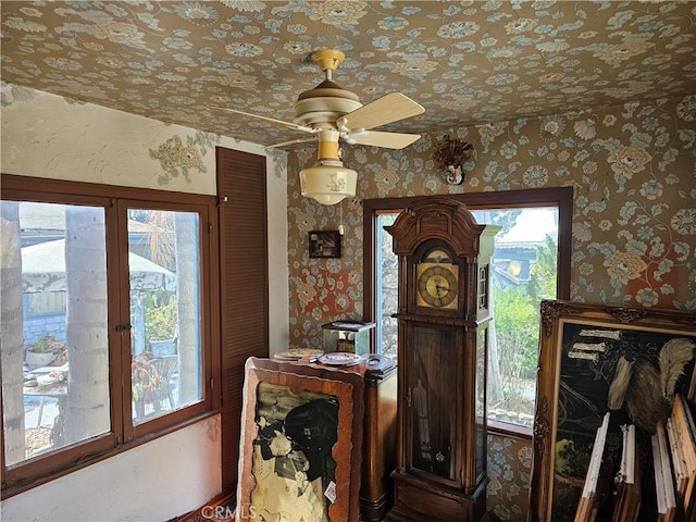 interior details featuring wallpapered walls and a ceiling fan