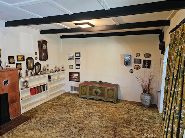 interior space with carpet floors, beam ceiling, and visible vents