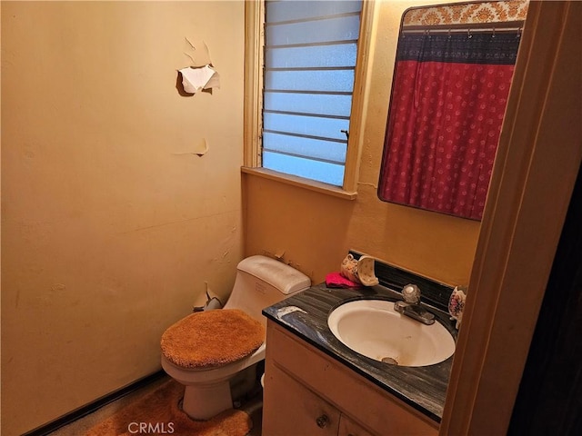 bathroom featuring vanity and toilet