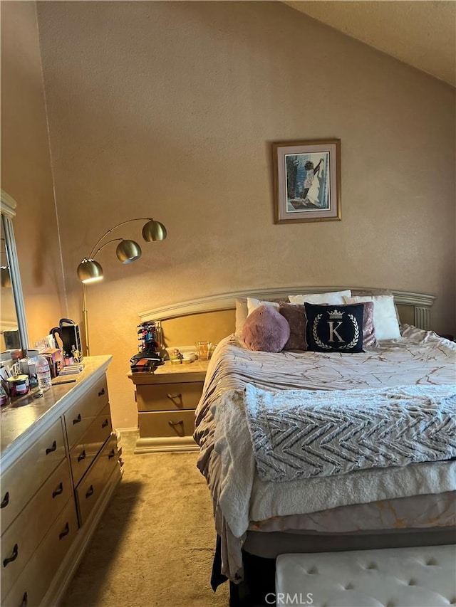 bedroom featuring lofted ceiling and light colored carpet