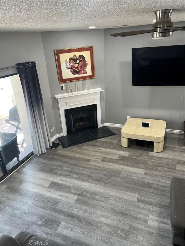 unfurnished living room featuring a fireplace, wood finished floors, and baseboards