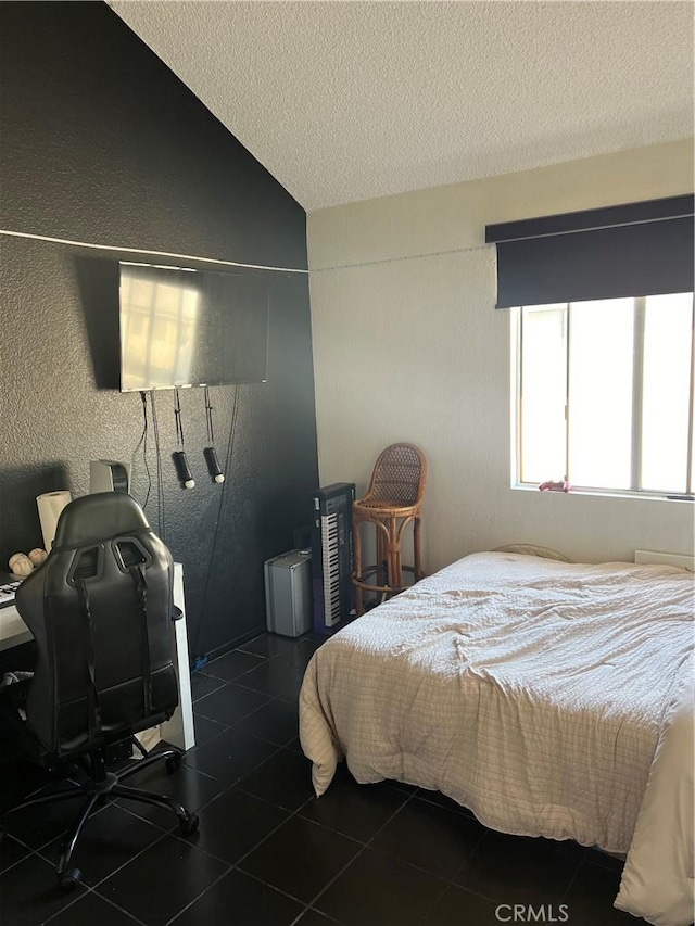 tiled bedroom with lofted ceiling, a textured ceiling, and a textured wall