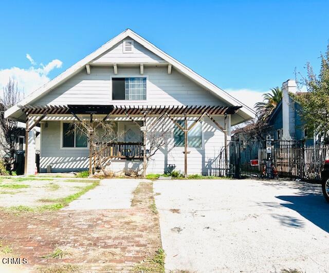 bungalow featuring fence, a porch, and a pergola