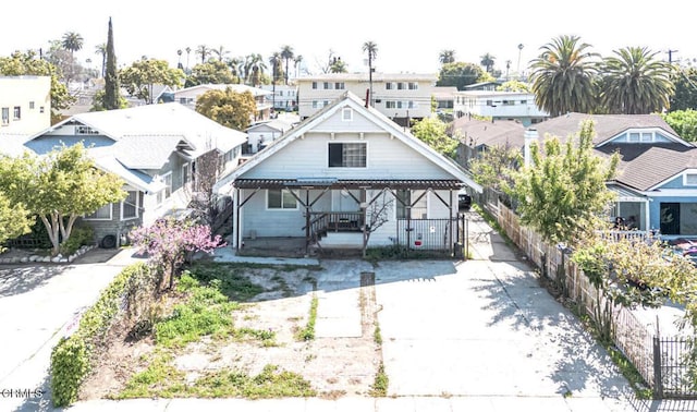 view of front of property featuring a residential view and fence