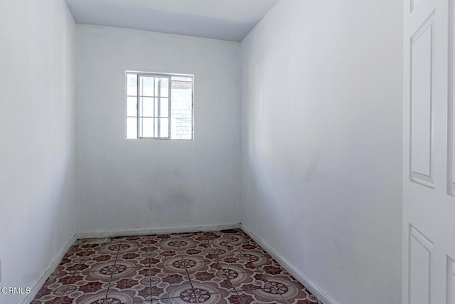 unfurnished room featuring baseboards