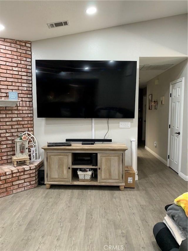 unfurnished living room with light wood-style floors, recessed lighting, visible vents, and baseboards