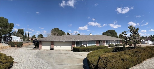 ranch-style home with an attached garage, driveway, and brick siding