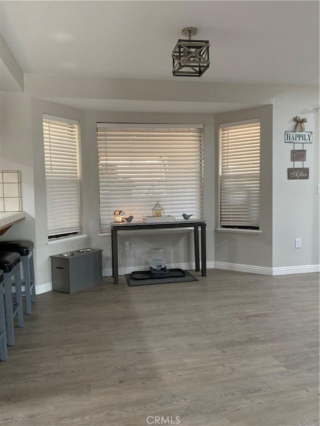 living area featuring wood finished floors and baseboards