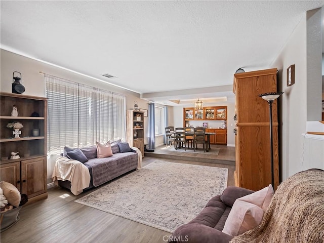 20312 Eyota Rd, Apple Valley, CA 92308 - living area with a notable chandelier, visible vents, a textured ceiling, and wood finished floors
