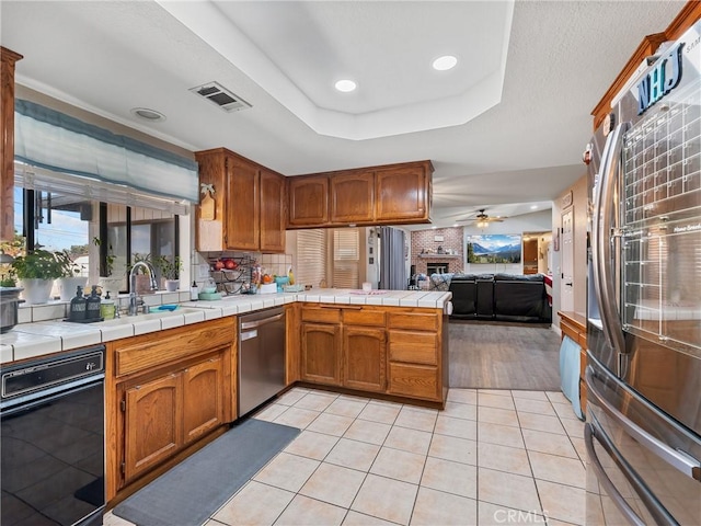20312 Eyota Rd, Apple Valley, CA 92308 - kitchen with brown cabinets, open floor plan, light tile patterned floors, a raised ceiling, and dishwasher