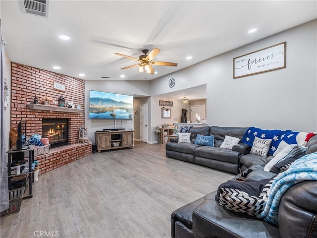 20312 Eyota Rd, Apple Valley, CA 92308 - living room with visible vents, a ceiling fan, wood finished floors, recessed lighting, and a brick fireplace