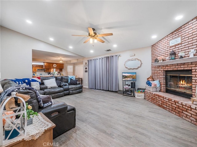 20312 Eyota Rd, Apple Valley, CA 92308 - living room featuring wood finished floors, recessed lighting, a fireplace, lofted ceiling, and ceiling fan
