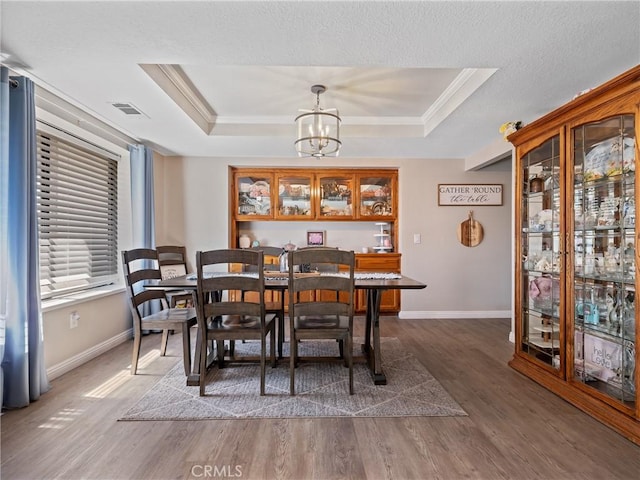 20312 Eyota Rd, Apple Valley, CA 92308 - dining room featuring a raised ceiling, a notable chandelier, wood finished floors, and visible vents