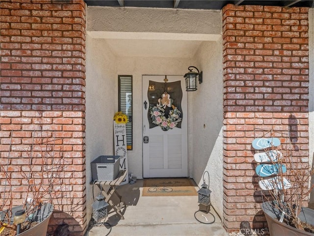 20312 Eyota Rd, Apple Valley, CA 92308 - doorway to property featuring brick siding and stucco siding