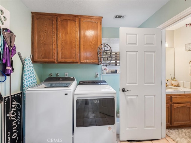 20312 Eyota Rd, Apple Valley, CA 92308 - laundry room featuring visible vents, cabinet space, washer and dryer, and a sink