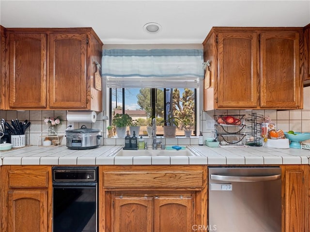 20312 Eyota Rd, Apple Valley, CA 92308 - kitchen with stainless steel dishwasher, brown cabinets, backsplash, and a sink