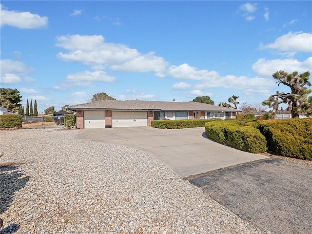 20312 Eyota Rd, Apple Valley, CA 92308 - ranch-style house with a garage, fence, brick siding, and driveway