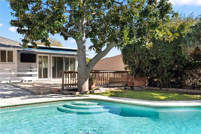 pool featuring a deck and a patio area