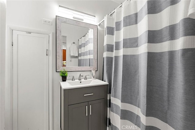 bathroom with curtained shower and vanity