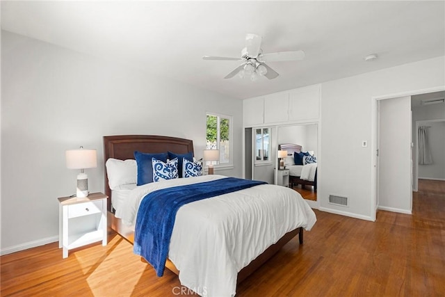 bedroom with visible vents, baseboards, and light wood-style floors