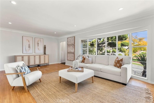 living area featuring recessed lighting, light wood finished floors, and ornamental molding