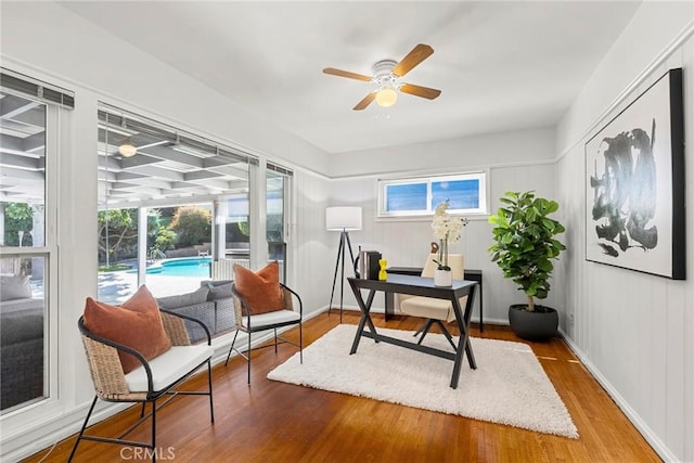 office featuring baseboards, wood finished floors, and a ceiling fan