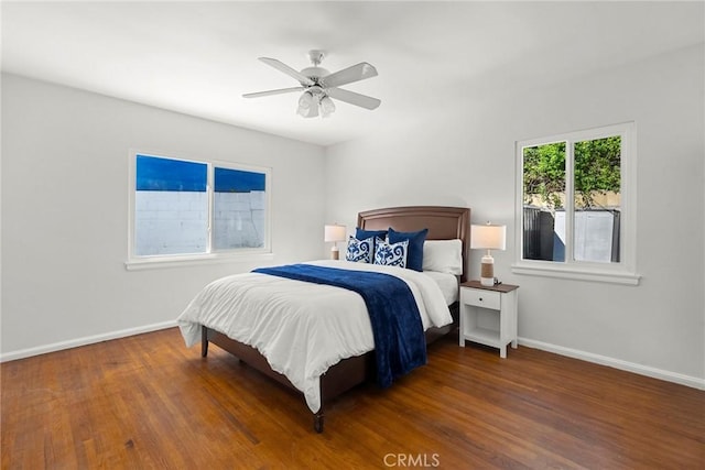 bedroom featuring wood finished floors, baseboards, and ceiling fan