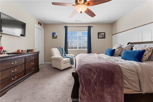 bedroom featuring light colored carpet, ceiling fan, and visible vents