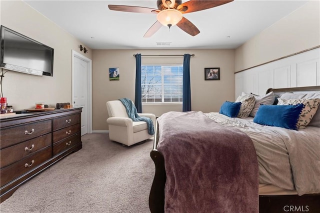 bedroom featuring light carpet, ceiling fan, and baseboards