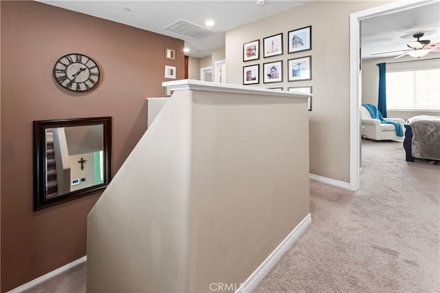 corridor with baseboards, visible vents, an upstairs landing, carpet floors, and recessed lighting