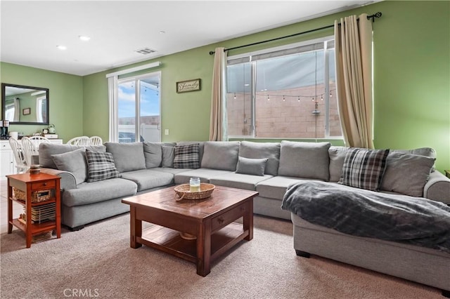 living room featuring carpet floors, recessed lighting, and visible vents