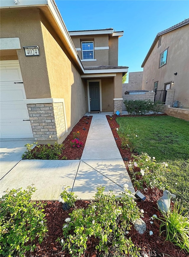 entrance to property featuring stucco siding