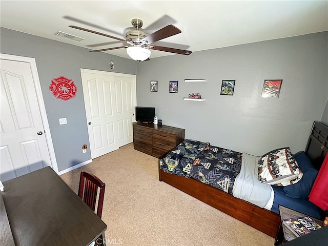 carpeted bedroom featuring a ceiling fan and a desk