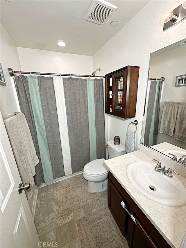 full bath featuring toilet and vanity