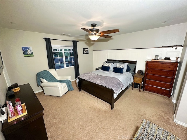 carpeted bedroom featuring ceiling fan and baseboards