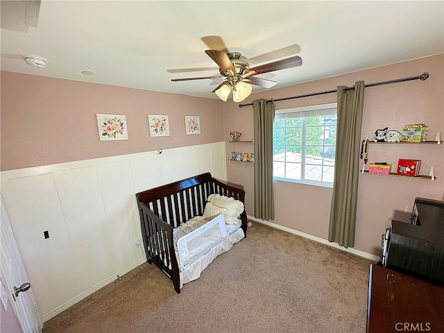 bedroom with light colored carpet, ceiling fan, and baseboards