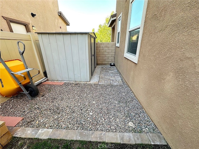 view of yard with fence, an outdoor structure, and a shed