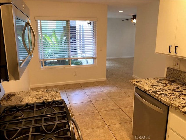 kitchen with white cabinetry, light tile patterned flooring, ceiling fan, light stone countertops, and dishwasher