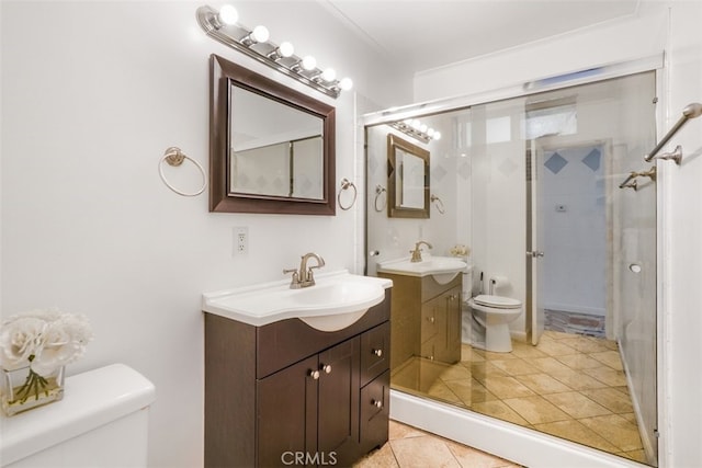 bathroom with walk in shower, two vanities, a sink, and toilet