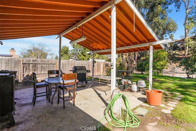 view of patio featuring fence and area for grilling