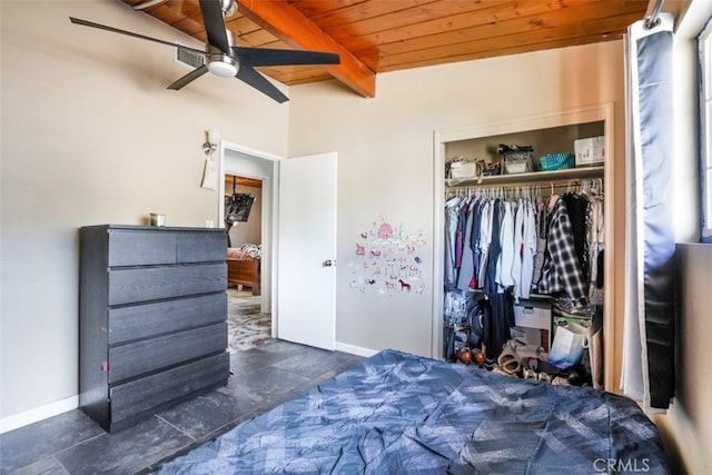 bedroom featuring a closet, wooden ceiling, baseboards, and beam ceiling