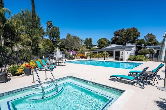 community pool featuring a patio area and fence