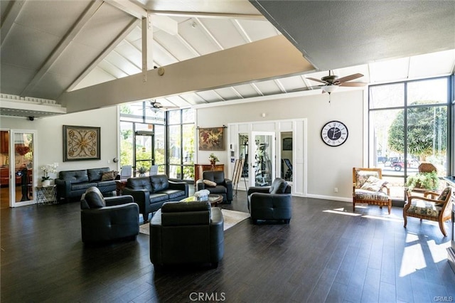 living area featuring expansive windows, ceiling fan, beamed ceiling, and wood finished floors