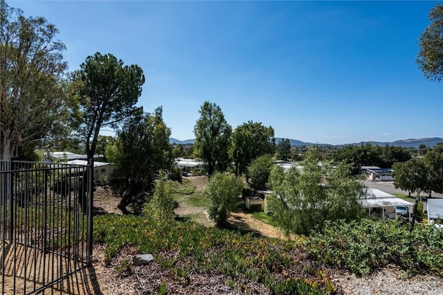 exterior space with fence and a mountain view