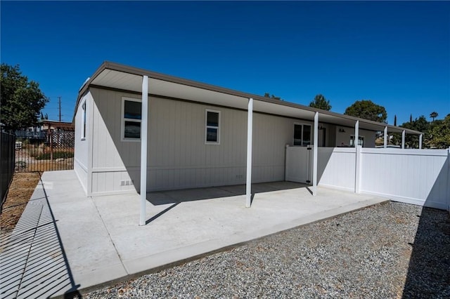 exterior space with crawl space, a patio area, and fence