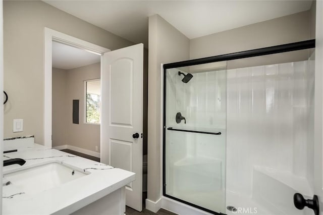 full bathroom featuring a stall shower and vanity