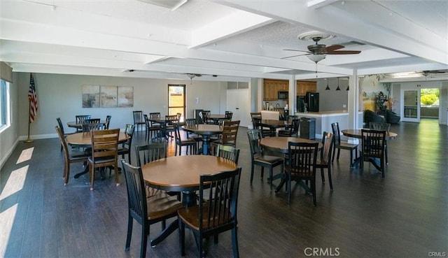 dining space featuring a ceiling fan, beam ceiling, baseboards, and wood finished floors