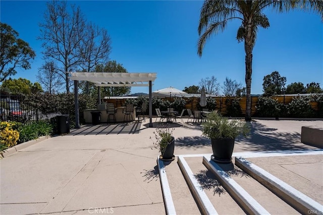 exterior space featuring fence, outdoor dry bar, and a pergola